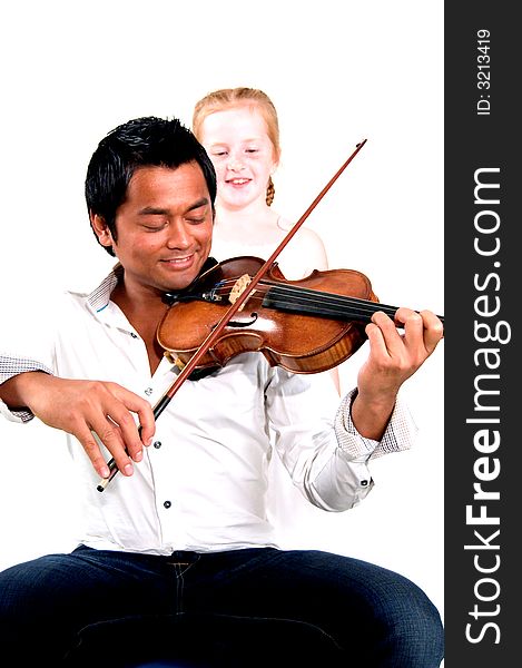 Man is playing the violin while little girl is listening (focus on violin). Man is playing the violin while little girl is listening (focus on violin)