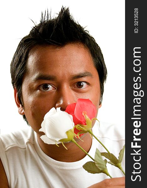 Handsome man is holding a white and red rose. Handsome man is holding a white and red rose