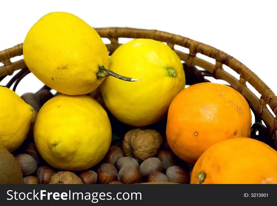 Lemon, oranges and hazelnuts isolated on white. Lemon, oranges and hazelnuts isolated on white