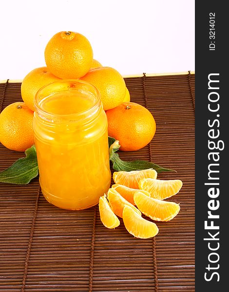 Orange Ripe tangerines on a white background with jam. Orange Ripe tangerines on a white background with jam