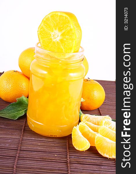 Orange Ripe tangerines on a white background with jam. Orange Ripe tangerines on a white background with jam