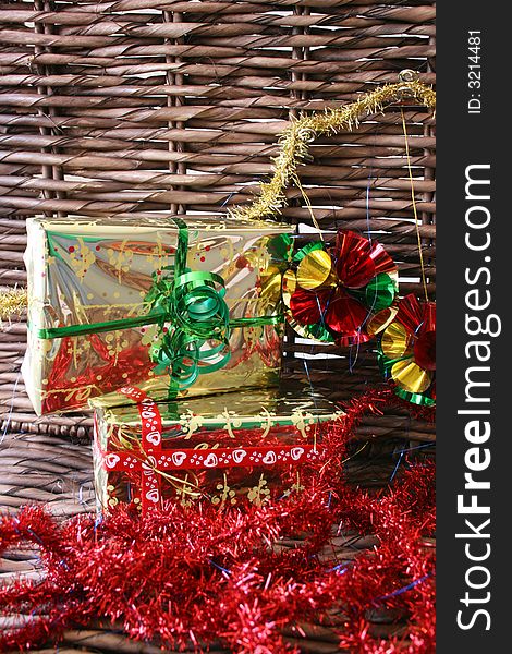 Christmas presents, tinsel and decorations on a rustic background