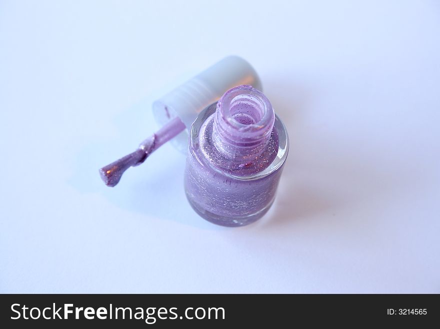 Purple Nail Polish and applicator on a white background