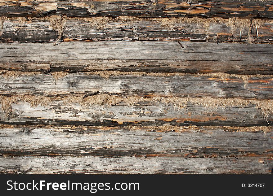 Texture of calked wooden wall made of logs. Buildings with such walls very common in north regions of Russia. Texture of calked wooden wall made of logs. Buildings with such walls very common in north regions of Russia.