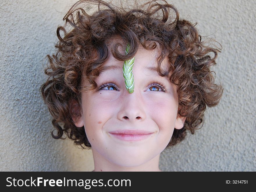 Tobacco horn worn crwling on boy's face. Tobacco horn worn crwling on boy's face