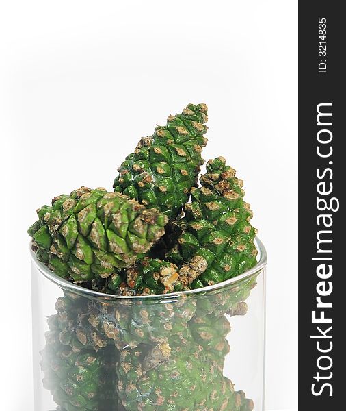 Nature, forest:  pine cones in glass bowl wite background