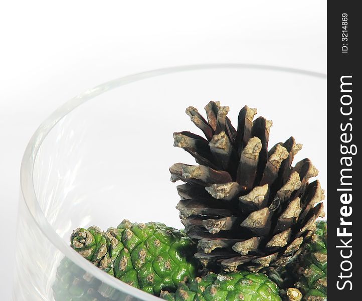 Nature, forest:  pine cones in glass bowl wite background