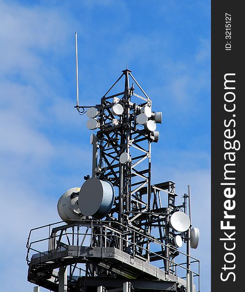 Communication mast showing range of antennas and dishes. Communication mast showing range of antennas and dishes.