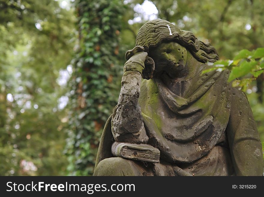 A sculpture of the mourning woman. Old graveyard.