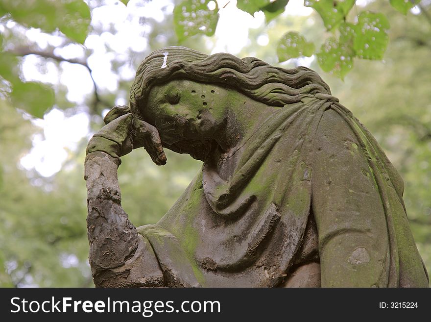 A sculpture of the mourning woman. Old graveyard.