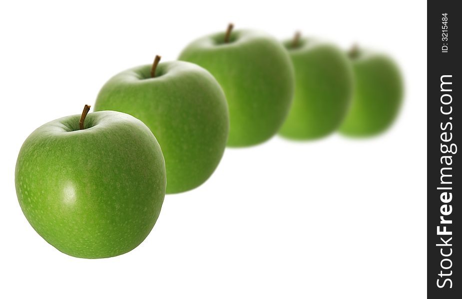 A row of green apples isolated on white background