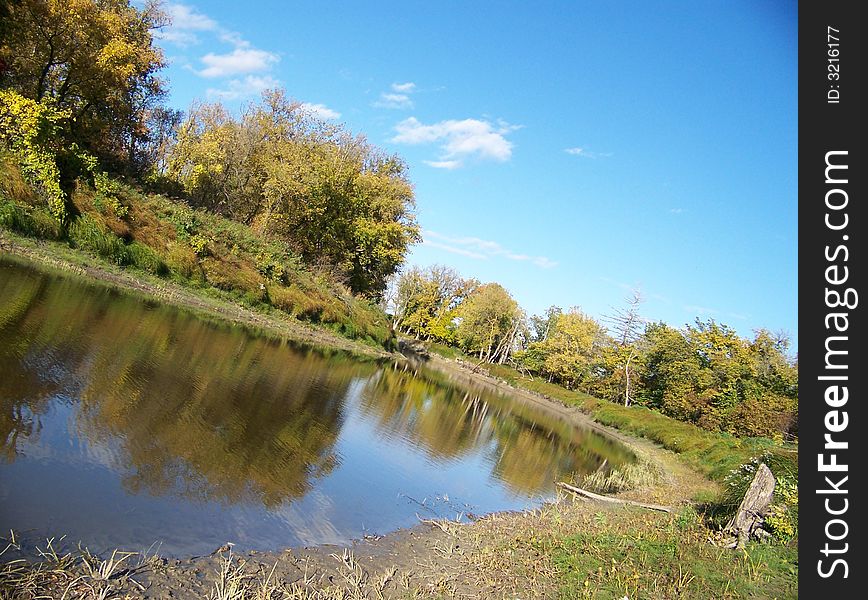 Gently curving flowing river with grassy banks. Gently curving flowing river with grassy banks.