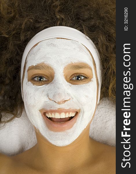 Young happy woman with white purifying mask. She looking at camera. Young happy woman with white purifying mask. She looking at camera.