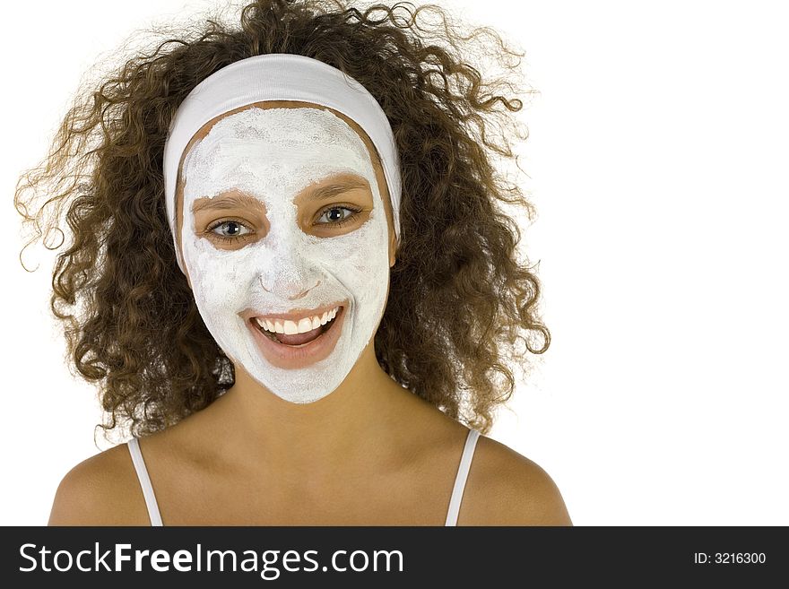 Young happy woman with white purifying mask. She's looking at camera. She's on white background. Young happy woman with white purifying mask. She's looking at camera. She's on white background.