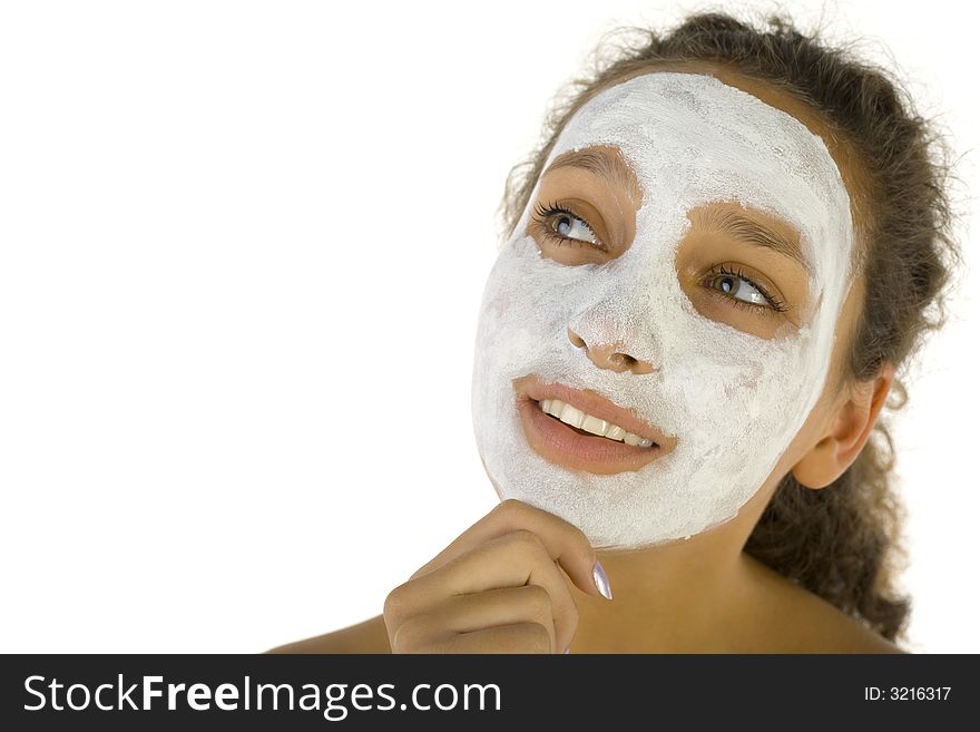 Thoughtful girl with purifying mask on face. She's on white background. Thoughtful girl with purifying mask on face. She's on white background