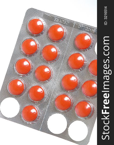 Photo of red tablets on a white background