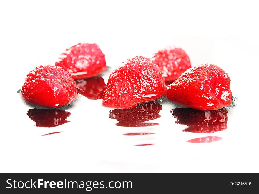 Image of some  strawberries with reflections in water. Image of some  strawberries with reflections in water
