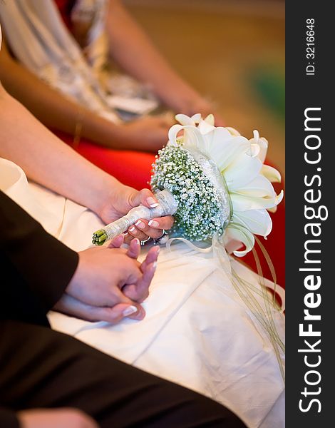 Bridal couple holding their hands while wedding-ceremony. Closeup to the hands. Bridal couple holding their hands while wedding-ceremony. Closeup to the hands.