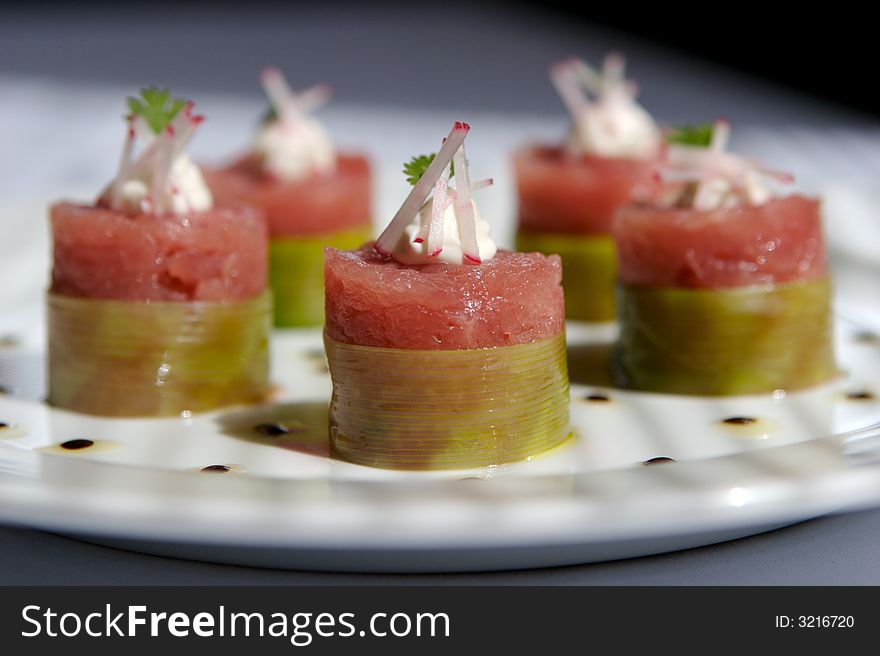 Five Tuna sushi with raddish rolled on a white plate