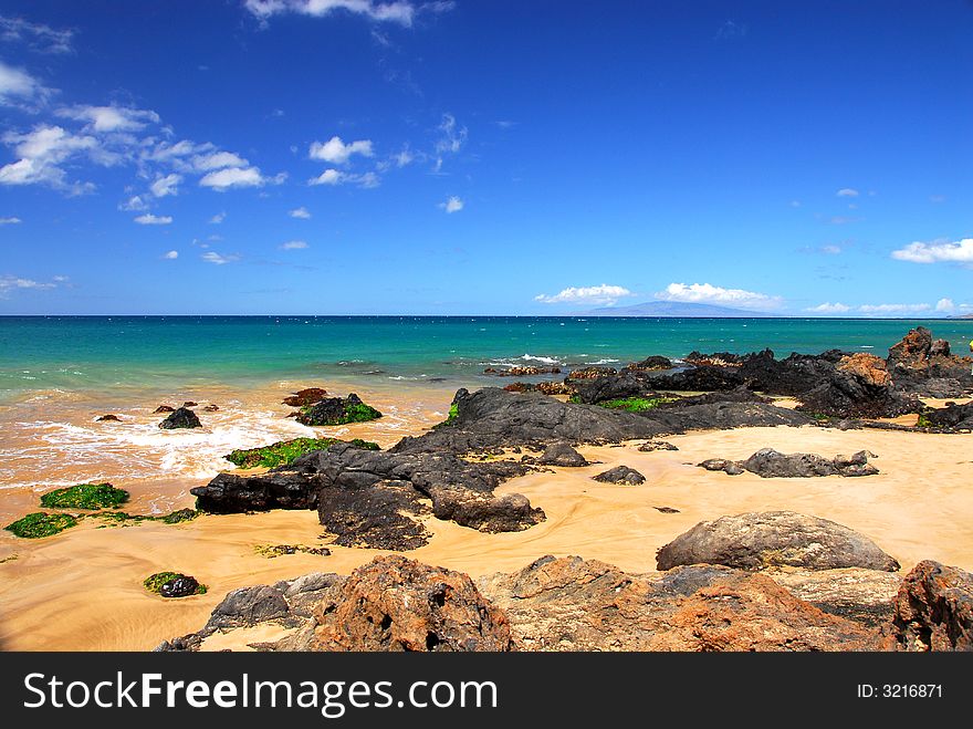 Large rocks on a pristine clear beach on the island of Maui. Large rocks on a pristine clear beach on the island of Maui