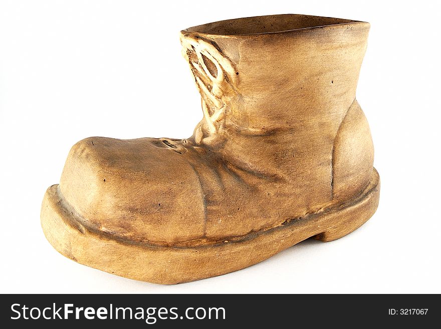 A brown ceramic boot form vase. A brown ceramic boot form vase