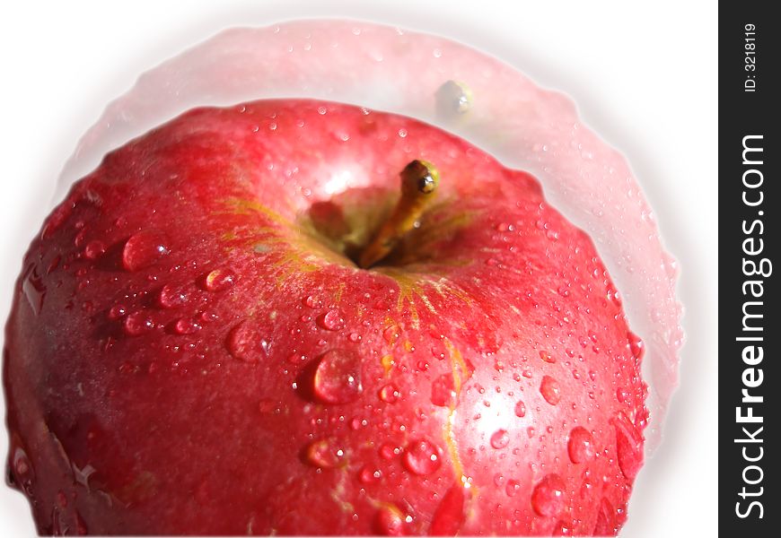 The big, juicy, red apple in drops of water.