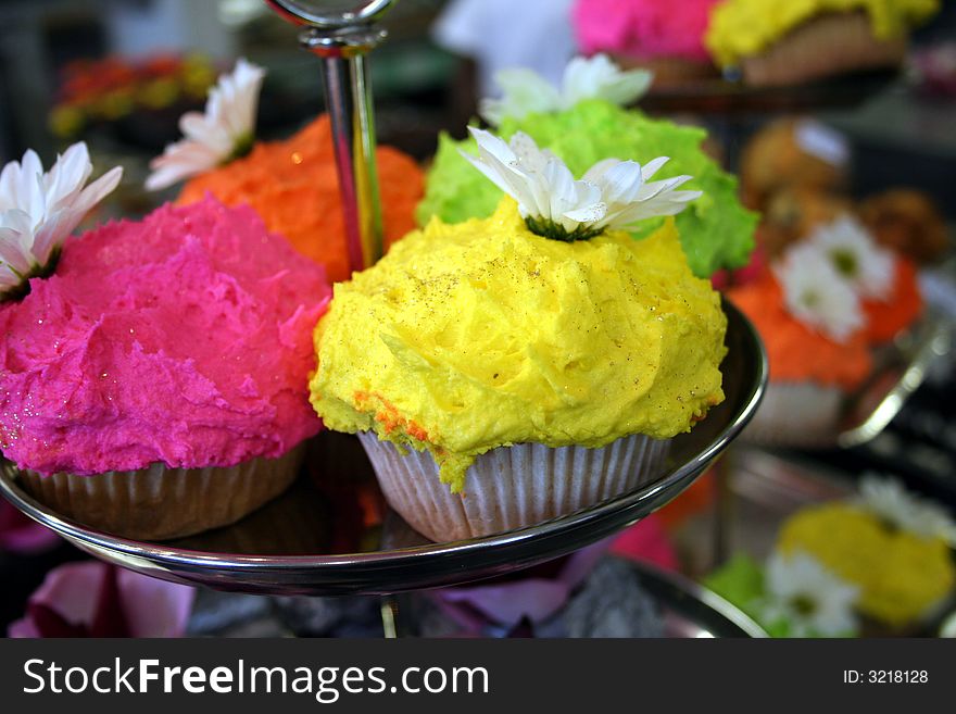 Platter of freshly baked colorful cupcakes