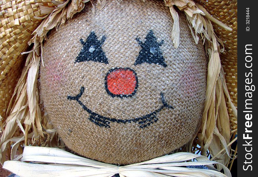 A close-up of a scarecrow decoration. A close-up of a scarecrow decoration