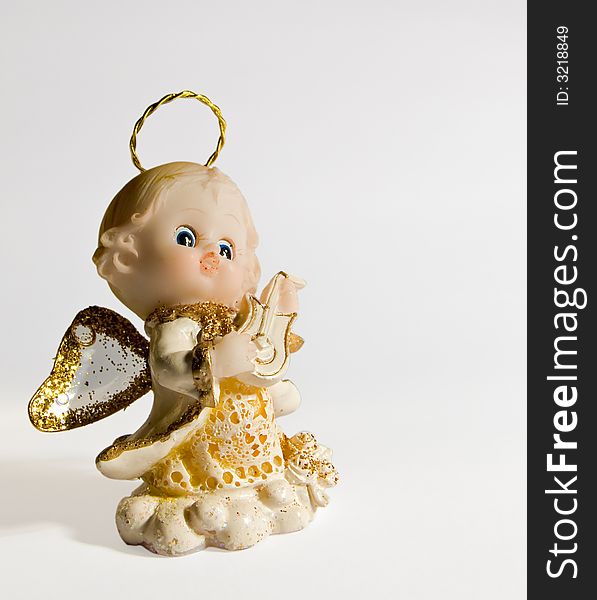 Small angel figurine, light background, isolated, two working path. Small angel figurine, light background, isolated, two working path.