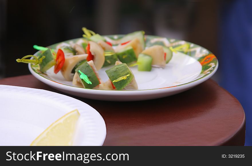 Assorted snack with cucumbers and mushrooms on a plate. Assorted snack with cucumbers and mushrooms on a plate