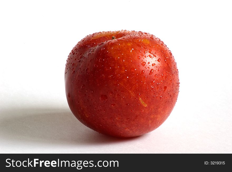 Dropped red plum on isolated white