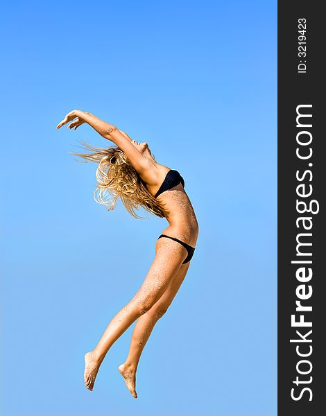 Jump of the young girl on a beach. Jump of the young girl on a beach