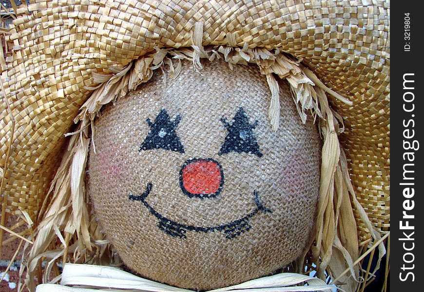 A close-up of a scarecrow decoration. A close-up of a scarecrow decoration