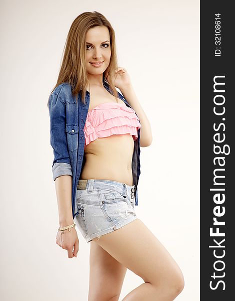 Beautiful and attractive female woman posing in blue jeans dress