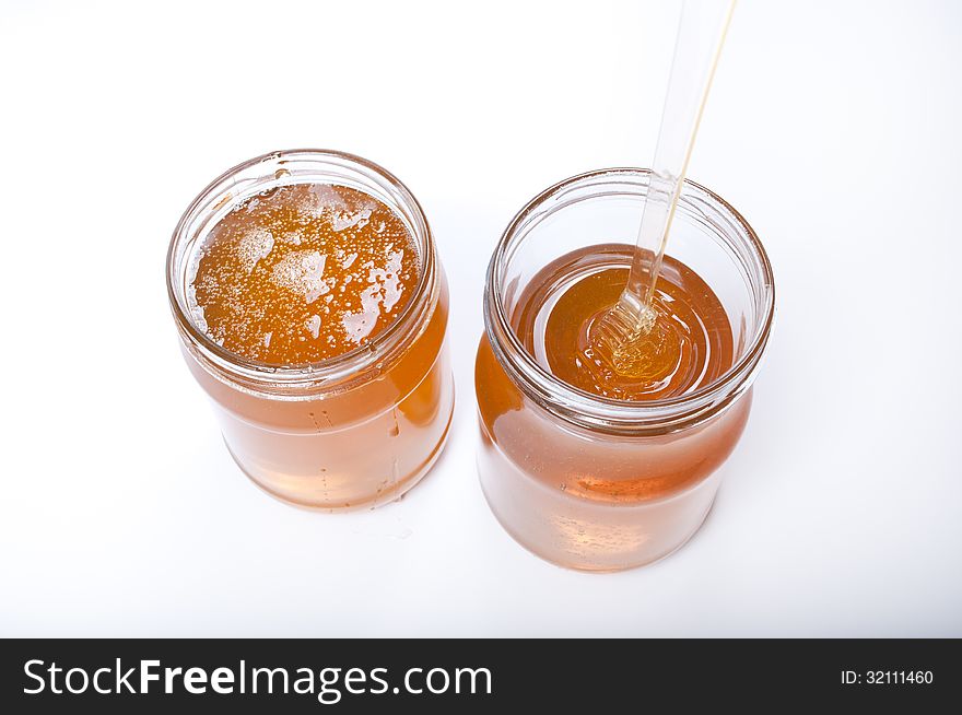 Two honey pots isolated on white background