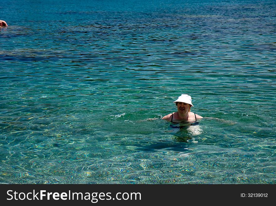 Woman making a bath in the greek sea. Woman making a bath in the greek sea