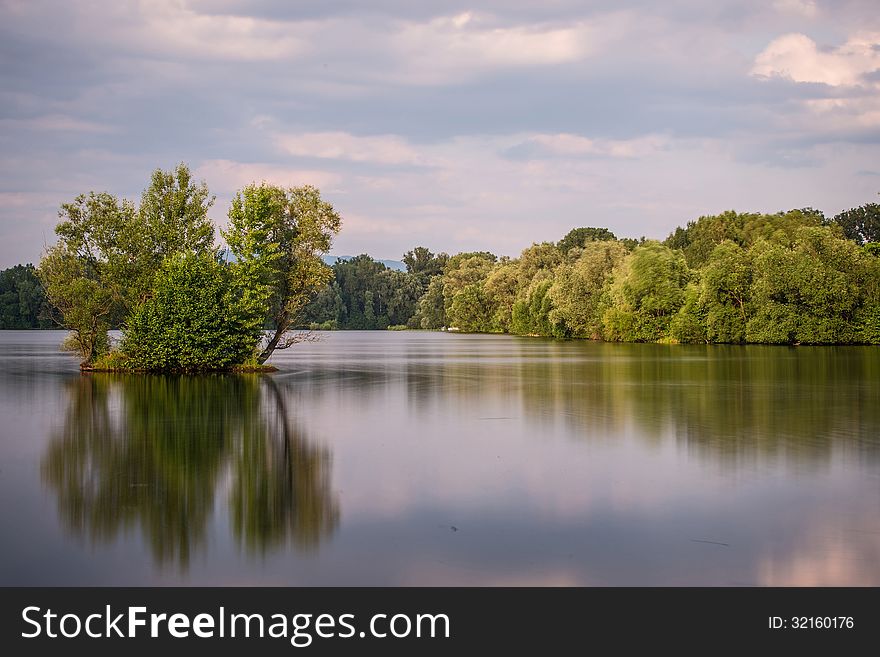 Sunrice behind lakes in the near forest