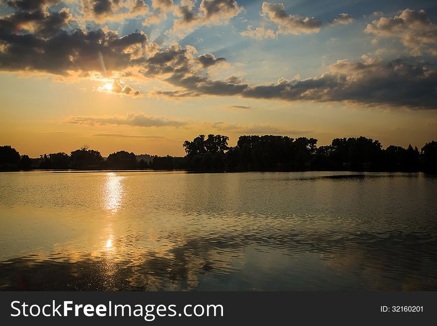 Sunrice behind lakes in the near forest