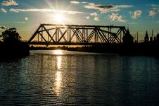 The Railway Bridge Through The River At Sunset Stock Images