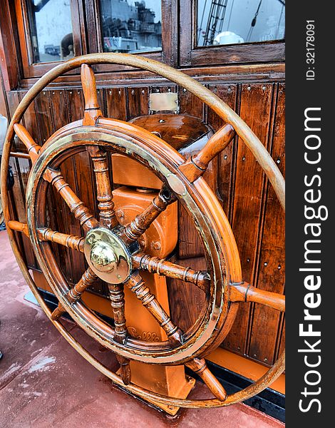 Steering wheel sailboat on old ship