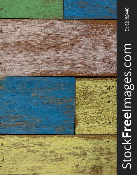 Detail of abstract art color wood wall yellow green blue