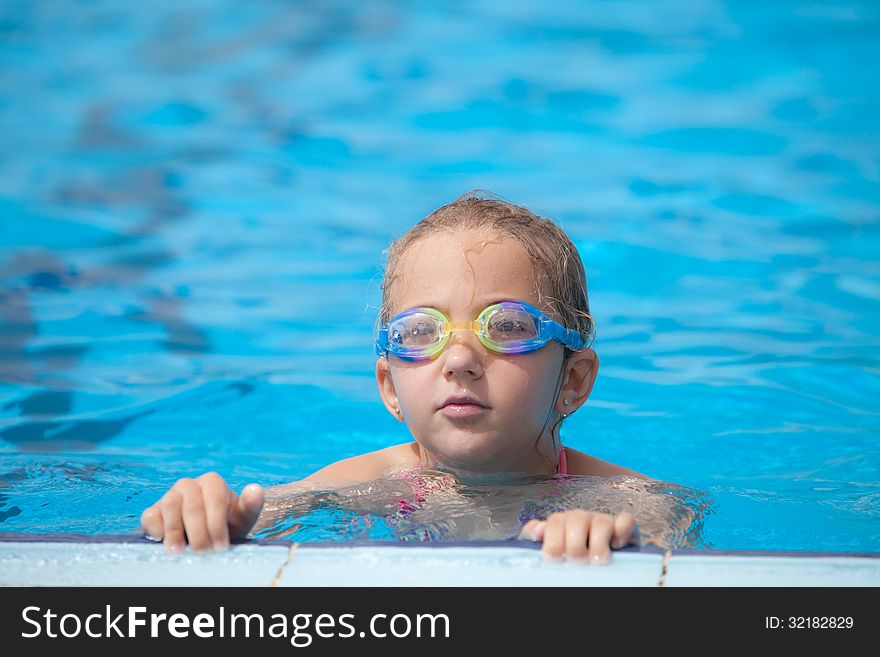 Girl swims in the pool