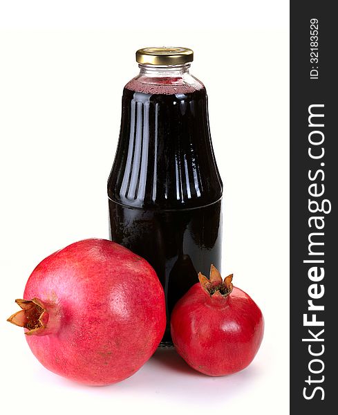 Bottle of juice and ripe pomegranate on white background