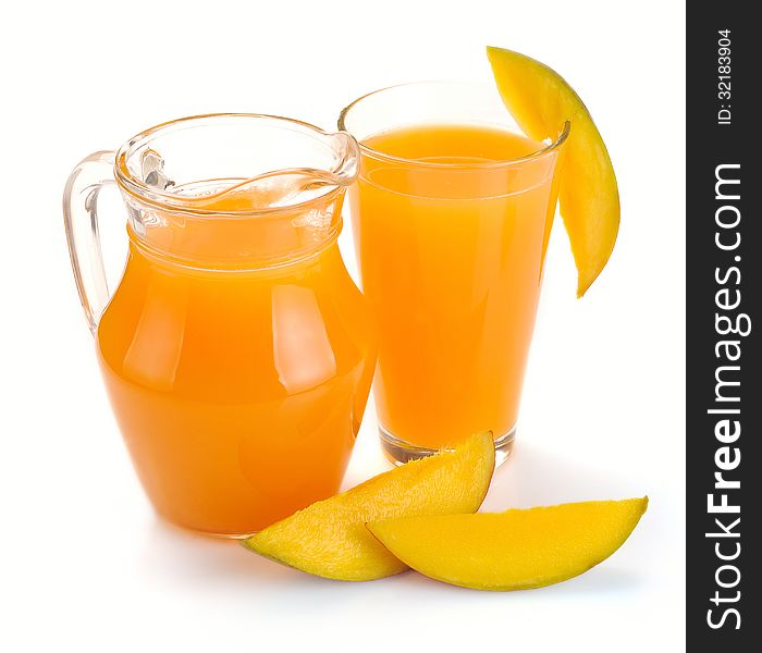 Mango juice in a jug and a glass of fruit. Mango juice in a jug and a glass of fruit