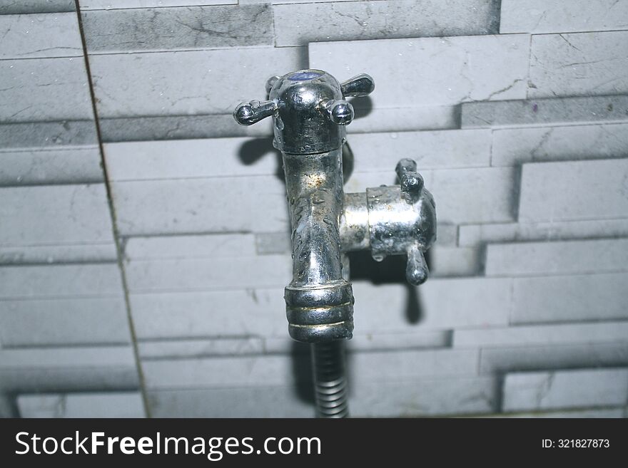 A Faucet That Has 2 Nozzles And Is Installed In The Bathroom.