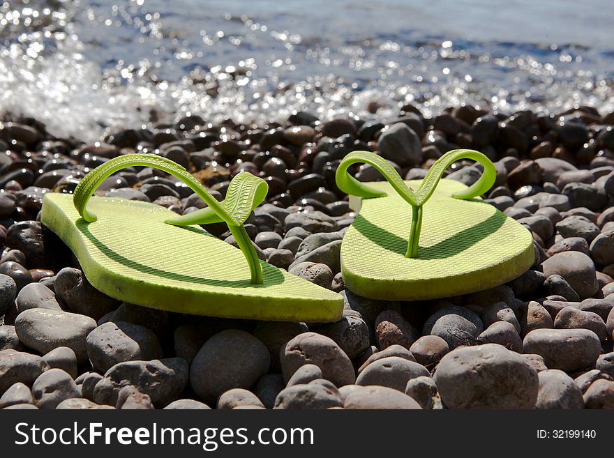 Green Flip-flops On The Pebble Beach