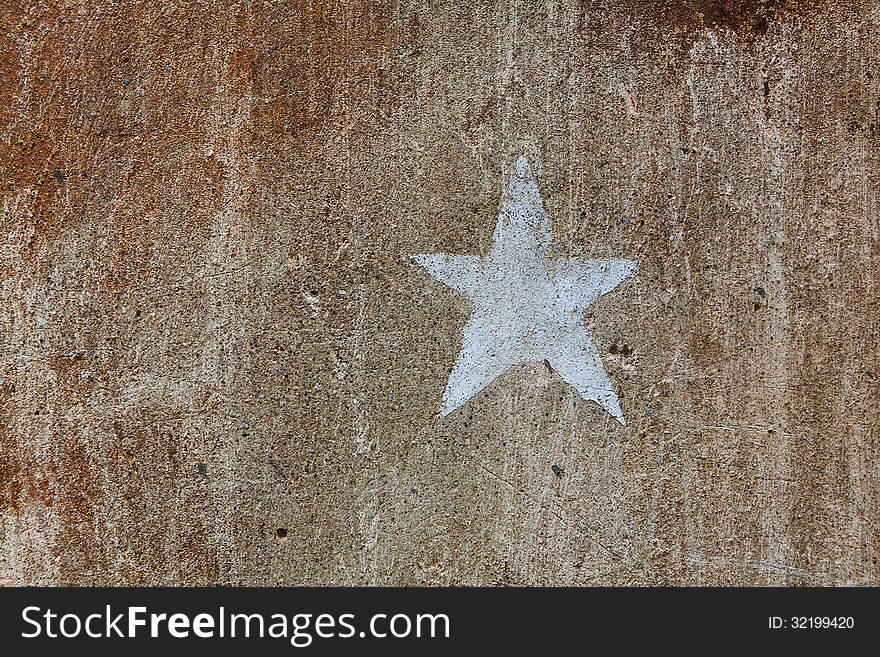 Old brown cement plaster wall background with star