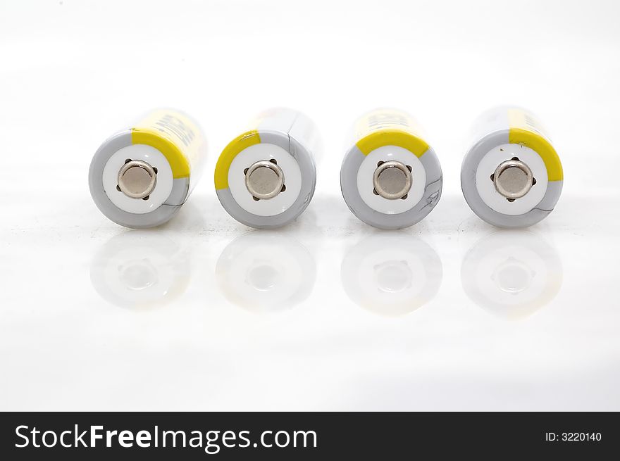 Four AA batteries on white background.