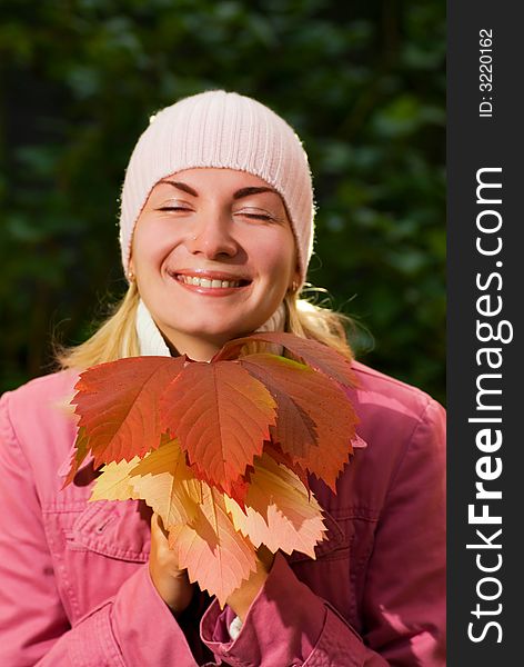 Young girl with autumn leaves