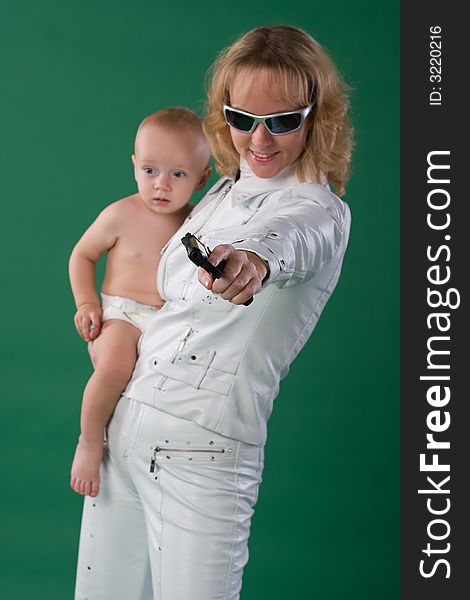 Woman with gun holds her son. Woman with gun holds her son